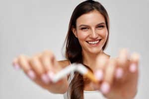 woman happily breaking a cigarette