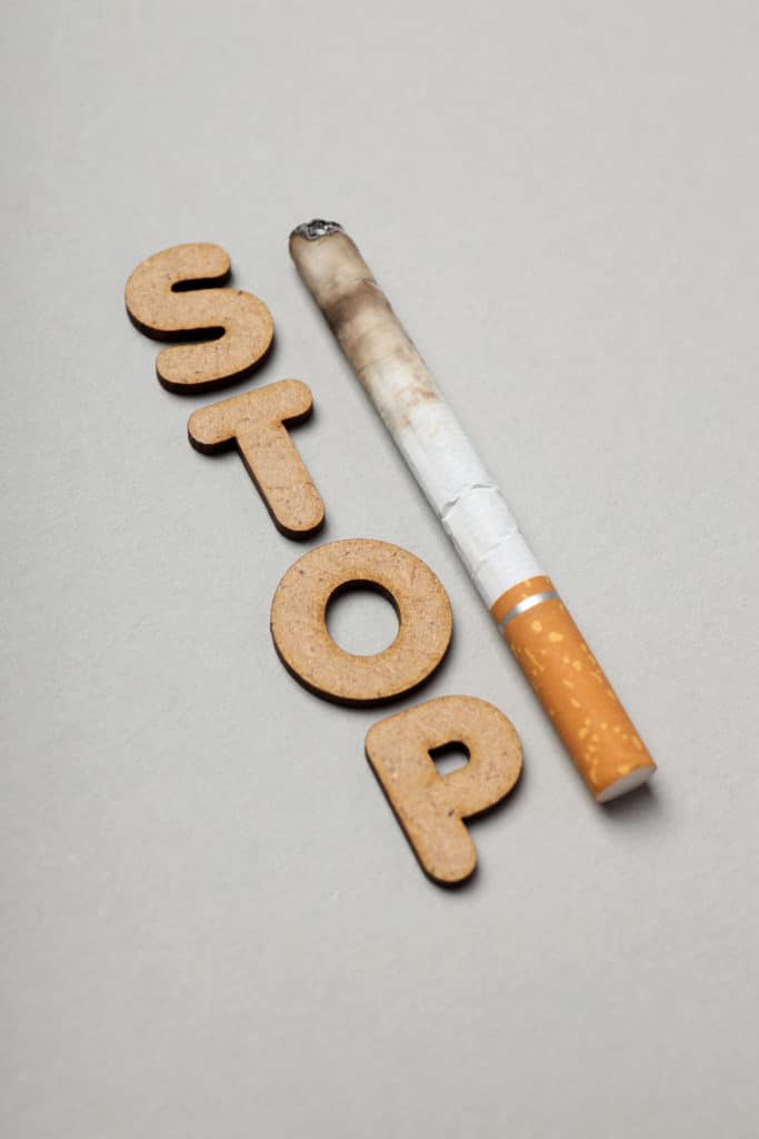 'Stop' words next to a cigarette. Stop Smoking.