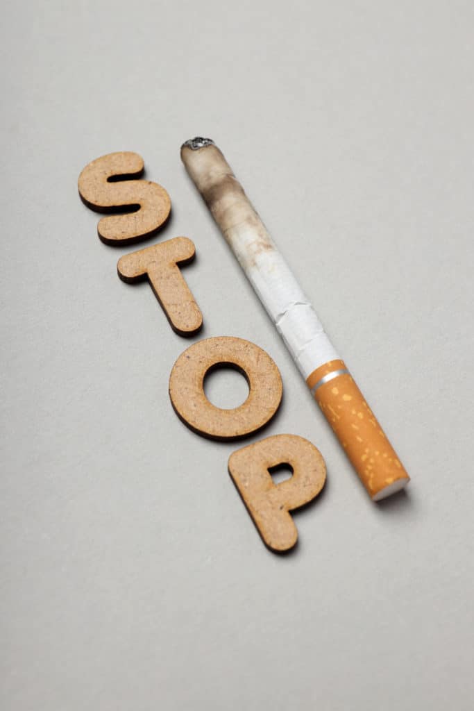 'Stop' words next to a cigarette. Stop Smoking.